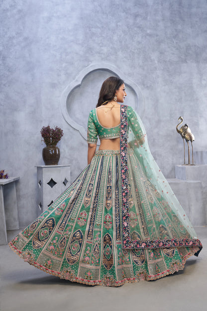 Organza Silk Intricate Paisley Motifs Traditional Embroidered Wedding Lehenga Choli In Green Color With Soft Net Dupatta