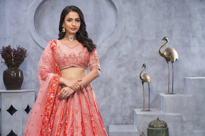 Organza Silk Intricate Paisley Motifs Traditional Embroidered Wedding Lehenga Choli In Pink color With Soft Net Dupatta